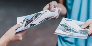 The Power of Tangible Marketing: Why Homeowners Pay Attention to a Door Hanger Delivery Service