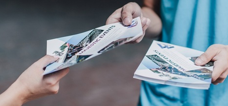 The Power of Tangible Marketing: Why Homeowners Pay Attention to a Door Hanger Delivery Service